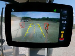 The embedded Motion Inhibit featureautomatically applies the brake when the system detects an object or worker in the critical alarm zone behind the loader. Image: Caterpillar